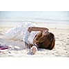 asian  bride with a veil on the beach in the sky and blue sea. honeymoon on the fantastic island at summer