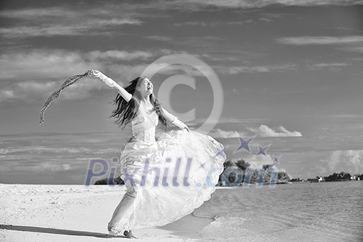asian bride with a veil on the beach in the sky and blue sea. honeymoon on the fantastic island at summer asian bride with a veil on the beach in the sky and blue sea. honeymoon on the fantastic island at summer