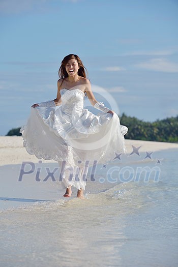asian bride with a veil on the beach in the sky and blue sea. honeymoon on the fantastic island at summer asian bride with a veil on the beach in the sky and blue sea. honeymoon on the fantastic island at summer