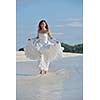 asian  bride with a veil on the beach in the sky and blue sea. honeymoon on the fantastic island at summer
