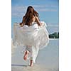 asian  bride with a veil on the beach in the sky and blue sea. honeymoon on the fantastic island at summer