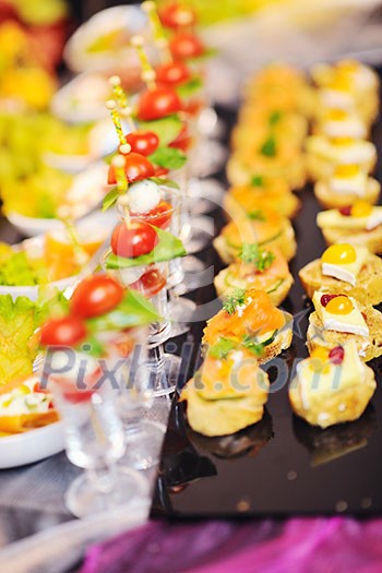 buffed food closeup of fruits, vegetables, meat and fish arranged on banquet table buffed food closeup of fruits, vegetables, meat and fish arranged on banquet table