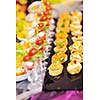 buffed food closeup of  fruits, vegetables, meat and fish arranged on banquet table