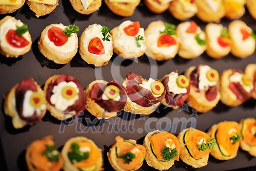 buffed food closeup of fruits, vegetables, meat and fish arranged on banquet table buffed food closeup of fruits, vegetables, meat and fish arranged on banquet table