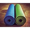 Vintage retro effect filtered hipster style image of Yoga mats on wooden floor