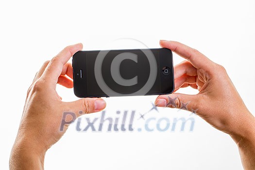 Female hand holding a smart phone, isolated on white Female hand holding a smart phone, isolated on white