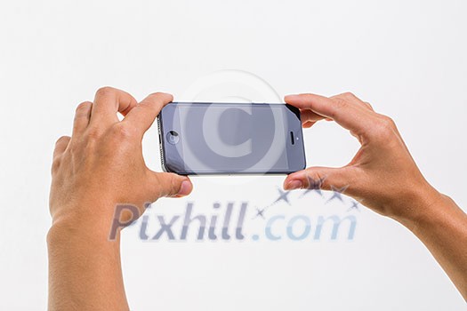 Female hand holding a smart phone, isolated on white Female hand holding a smart phone, isolated on white