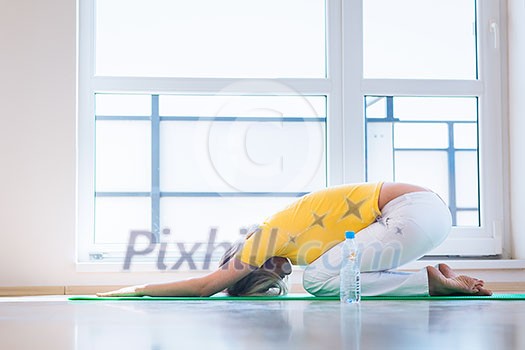 Pretty young woman doing YOGA exercise at home Pretty young woman doing YOGA exercise at home