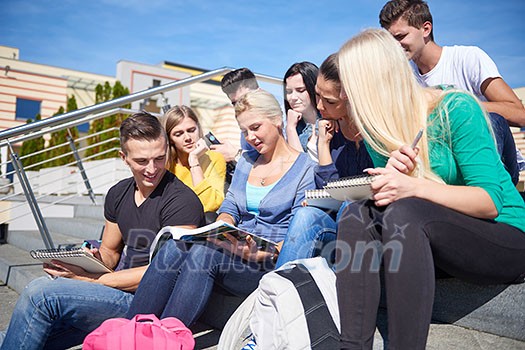 Group portrait of happy students outside sitting on steps have fun Group portrait of happy students outside sitting on steps have fun