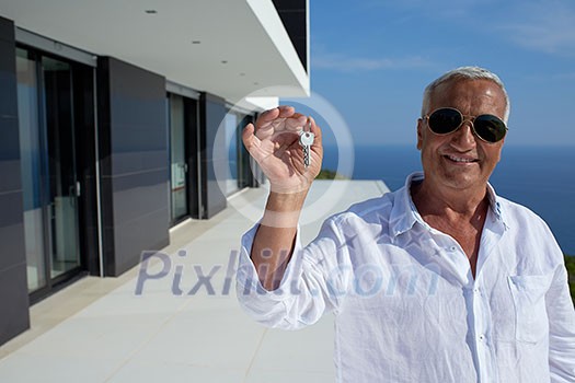senior man in front of luxury modern home villa senior man in front of luxury modern home villa