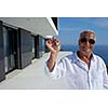 senior man in front of luxury modern home villa