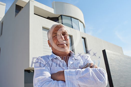senior man in front of luxury modern home villa senior man in front of luxury modern home villa