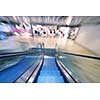 Shopping mall center escalators. Zoom blur movement.