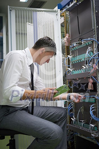 network engineer working in server room, corporate business man working on tablet computer network engineer working in server room, corporate business man working on tablet computer