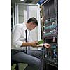 network engineer working in  server room, corporate business man working on tablet computer