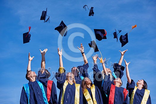 high school students graduates tossing up hats over blue sky. high school students graduates tossing up hats over blue sky.