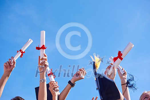 high school students graduates tossing up hats over blue sky. high school students graduates tossing up hats over blue sky.