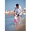 happy mom and baby on beach  have fun while learning to walk and  make first steps
