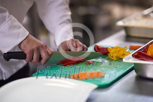 chef in hotel kitchen slice vegetables with knife and prepare food chef in hotel kitchen slice vegetables with knife and prepare food