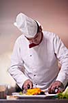 chef in hotel kitchen preparing and decorating food, delicious vegetables and meat  meal dinner