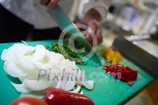 chef in hotel kitchen slice vegetables with knife and prepare food chef in hotel kitchen slice vegetables with knife and prepare food
