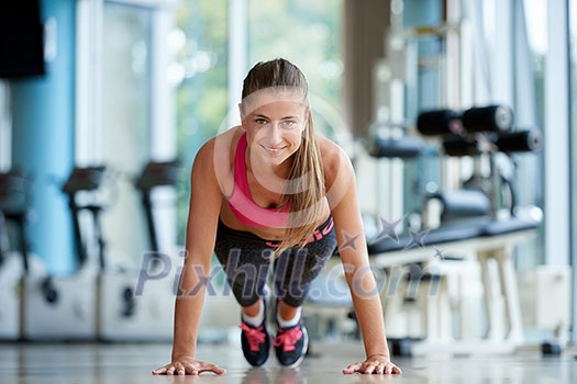 Gorgeous blonde woman warming up and doing some push ups a the gym Gorgeous blonde woman warming up and doing some push ups a the gym