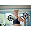 healthy and fit young woman in fitness gym lifting weights and working on her butt muscles