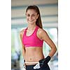young fit woman measuring belly on a training  in  fitness gym
