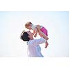happy mom and baby on beach  have fun while learning to walk and  make first steps