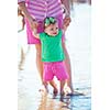 happy mom and baby on beach  have fun while learning to walk and  make first steps