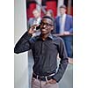 Happy smiling successful African American businessman  in a suit in a modern bright office indoors
