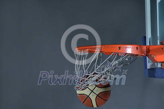 Basketball ball, board and net on grey background in gym indoor Basketball ball, board and net on grey background in gym indoor