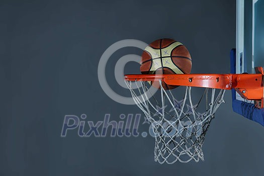 Basketball ball, board and net on grey background in gym indoor Basketball ball, board and net on grey background in gym indoor
