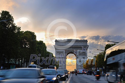 Beautiful night view with car traffic and rush at eavning of the Arc de Triomphe, Paris, France. Beautiful night view with car traffic and rush at eavning of the Arc de Triomphe, Paris, France.