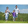 happy young family with their kids have fun and relax outdoors in nature with blue sky in background