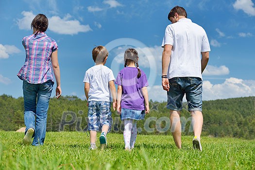 happy young family with their kids have fun and relax outdoors in nature with blue sky in background happy young family with their kids have fun and relax outdoors in nature with blue sky in background