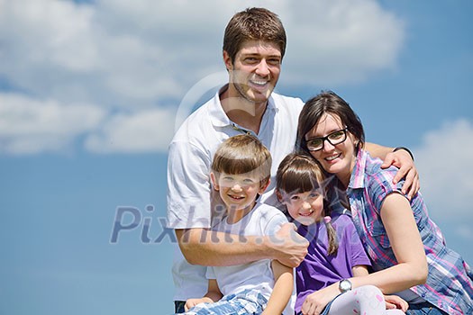 happy young family with their kids have fun and relax outdoors in nature with blue sky in background happy young family with their kids have fun and relax outdoors in nature with blue sky in background