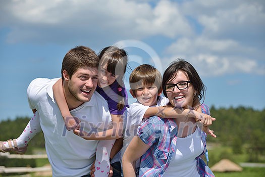 happy young family with their kids have fun and relax outdoors in nature with blue sky in background happy young family with their kids have fun and relax outdoors in nature with blue sky in background