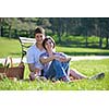 happy young romantic couple in love   having a picnic outdoor on a summer day