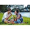 happy young romantic couple in love   having a picnic outdoor on a summer day