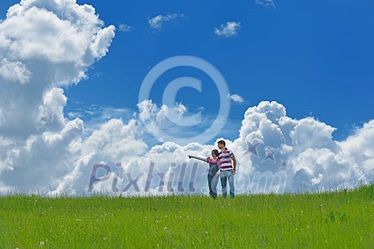 Portrait of romantic young couple in love smiling together outdoor in nature with blue sky in background Portrait of romantic young couple in love smiling together outdoor in nature with blue sky in background