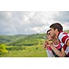 Portrait of romantic young couple in love  smiling together outdoor in nature with blue sky in background