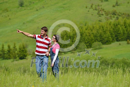 Portrait of romantic young couple in love smiling together outdoor in nature with blue sky in background Portrait of romantic young couple in love smiling together outdoor in nature with blue sky in background