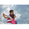 Portrait of romantic young couple in love  smiling together outdoor in nature with blue sky in background