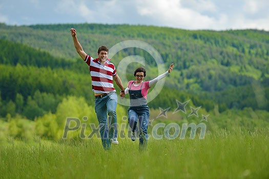 Portrait of romantic young couple in love smiling together outdoor in nature with blue sky in background Portrait of romantic young couple in love smiling together outdoor in nature with blue sky in background