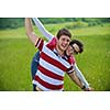 Portrait of romantic young couple in love  smiling together outdoor in nature with blue sky in background