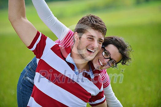 Portrait of romantic young couple in love smiling together outdoor in nature with blue sky in background Portrait of romantic young couple in love smiling together outdoor in nature with blue sky in background