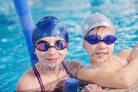happy children kids group at swimming pool class learning to swim happy children kids group at swimming pool class learning to swim