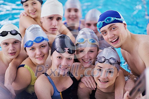 happy teen group at swimming pool class learning to swim and have fun happy teen group at swimming pool class learning to swim and have fun