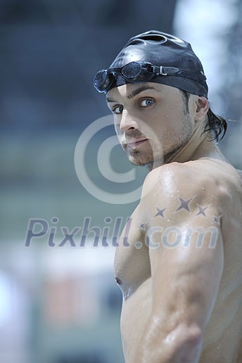 young healthy with muscular body man swim on swimming pool and representing healthy and recreation concept young healthy with muscular body man swim on swimming pool and representing healthy and recreation concept